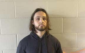 This undated handout photo distributed by the US Attorney's Office for the Central District of California shows Jonathan Rinderknecht, 29, following his arrest by federal authorities in Florida. Authorities investigating one of the deadly fires that tore through Los Angeles in January said on October 8, 2025, they had arrested Jonathan Rinderknecht, who they believe deliberately started the blaze. The arrest comes as America's second-largest city is still grappling with the aftermath of two huge fires that together killed 31 people and left thousands of acres (hectares) in ruins, as they displaced thousands of people. Rinderknecht's initial court appearance is scheduled for Wednesday afternoon. (Photo by HANDOUT / US Attorney's Office for the Central District of California / AFP) / RESTRICTED TO EDITORIAL USE - MANDATORY CREDIT "AFP PHOTO /  US ATTORNEY'S OFFICE FOR THE CENTRAL DISTRICT OF CALIFORNIA/ HANDOUT" - HANDOUT - NO MARKETING NO ADVERTISING CAMPAIGNS - DISTRIBUTED AS A SERVICE TO CLIENTS