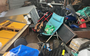 The contents of Derek Judge and his partner's garage are all over the place after being swished about by floodwaters from the rapidly rising Waimoko Stream.