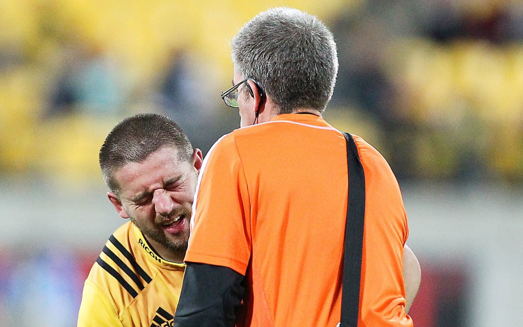 Hurricanes captain Dane Coles receives treatment.