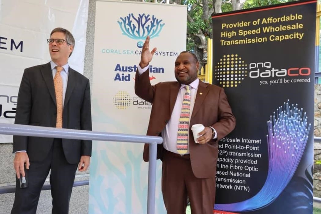 Papua New Guinea Prime Minister James Marape (right) celebrates the launch of the Coral Sea Cable Project with Australian High Commissioner Jon Philp in Port Moresby, 5 June 2020.