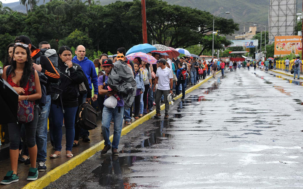 Venezuelans cross the Simon Bolivar bridge linking San Antonio del Tachira, in Venezuela with Cucuta, Colombia, to buy basic supplies.