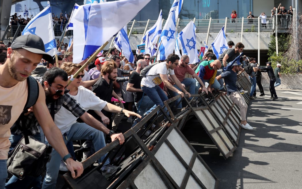 Protesters break police barricades during a demonstration against the Israeli government's controversial justice reform bill in Tel Aviv on 1 March, 2023.