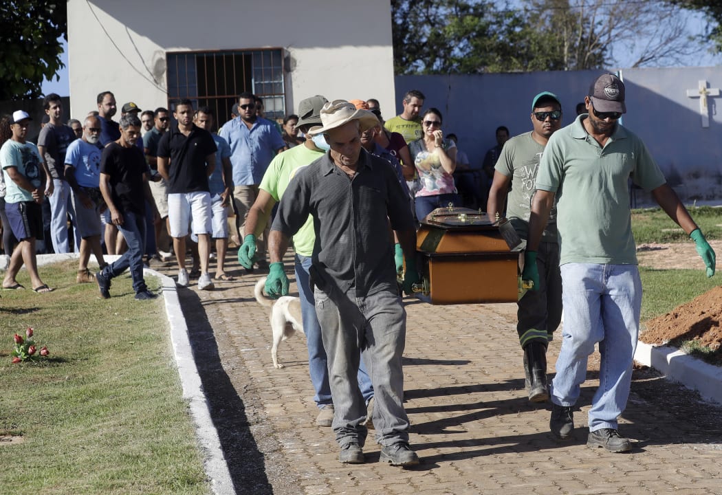 Cemetery workers carry the coffin with the body of Vale SA employee Edgar Carvalho Santos, victim of the collapsed dam, in Brumadinho, Brazil on Tuesday, 29 January.