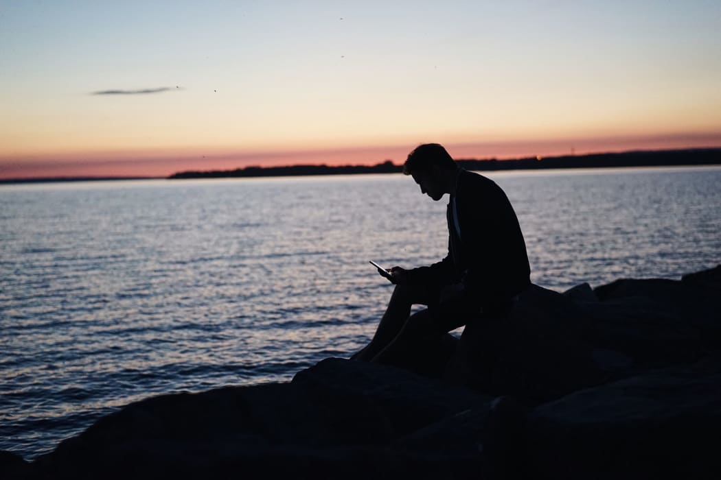 guy on phone at sunset