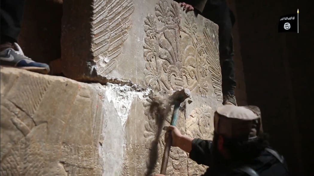 The video shows militants dismantling and destroying ancient stonework.