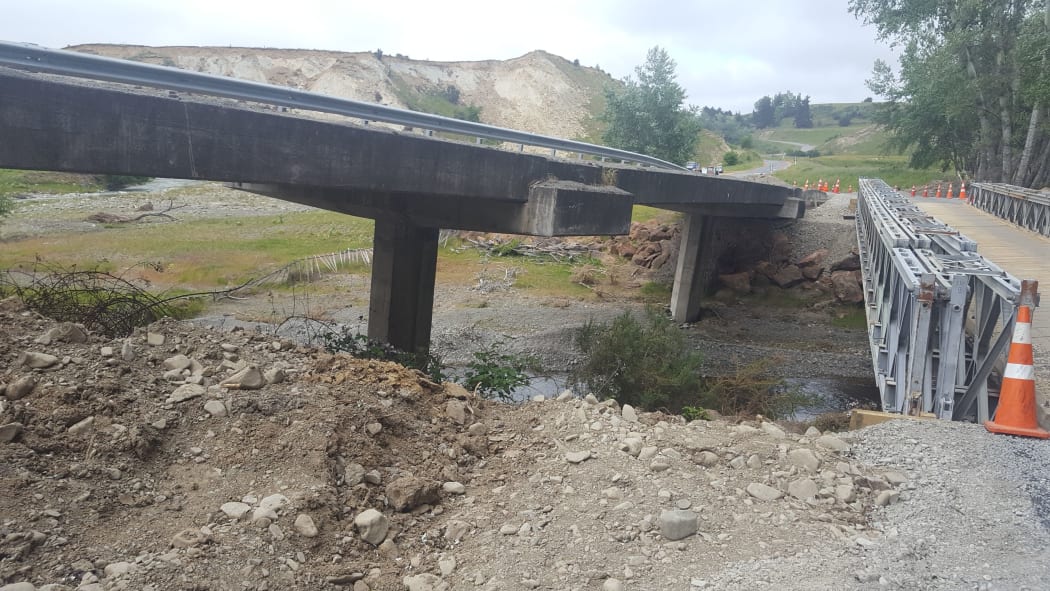 A damaged bridge and temporary replacement bridge on the road between Waiau and Mt Lyford.