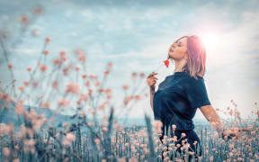 woman with flower in field