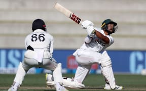 Bangladesh's Najmul Hossain Shanto (R with Blackcaps Henry Nicholls during play on day two of the first cricket test between Bangladesh and New Zealand at Bay Oval in Mount Maunganui