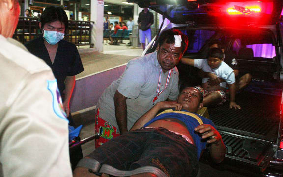 Thai hospital workers evacuate an injured villager after the attack.