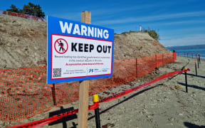 A sign warning of contaminated sawdust, which has been found to contain high levels of heavy metals.