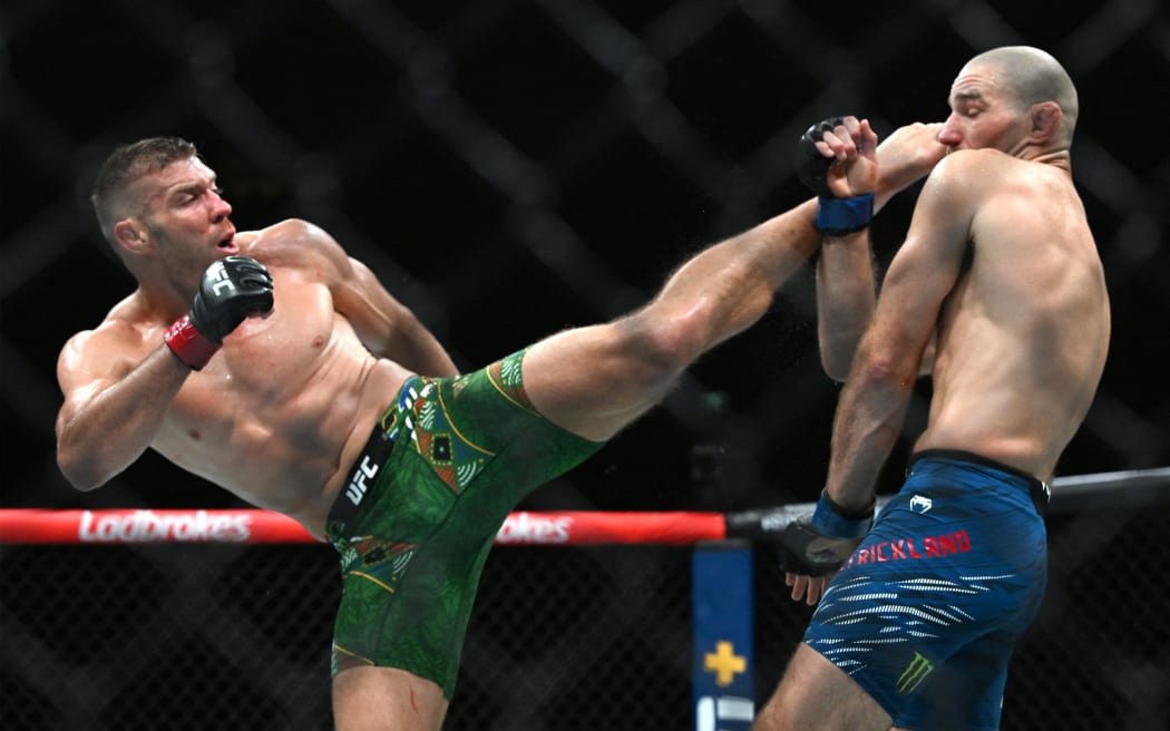 South Africa's Dricus du Plessis (L) and Sean Strickland of the US fight in their men's middleweight division event of the Ultimate Fighting Championship (UFC) 312 at Qudos Bank Arena in Sydney on February 9, 2025. (Photo by Saeed KHAN / AFP) / -- IMAGE RESTRICTED TO EDITORIAL USE - STRICTLY NO COMMERCIAL USE --