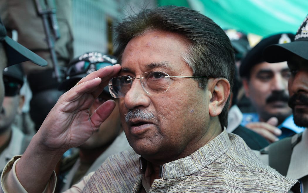 In this file photo taken on April 20, 2013 former Pakistani president Pervez Musharraf (C) is escorted by soldiers as he salutes on his arrival at an anti-terrorism court in Islamabad.