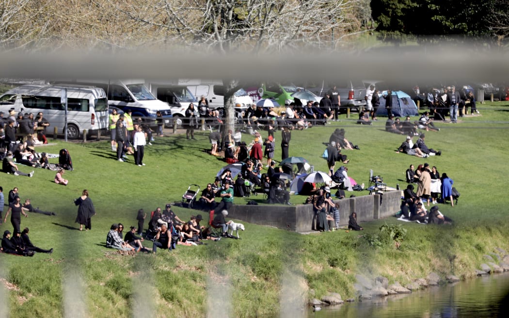 Crowds outside Turangawaewae Marae wait for Kiingi Tuheitia's body to be transported up the Waikato river to his final resting place at Taupiri maunga