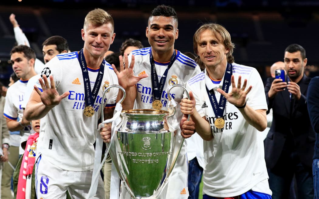 28th May 2022;  Stade de France stadium, Saint-Denis, Paris, France. Champions League football final between Liverpool FC and Real Madrid; Luka Jovic, Toni Kroos and Casemiro of Real Madrid pose with the Champions League trophy