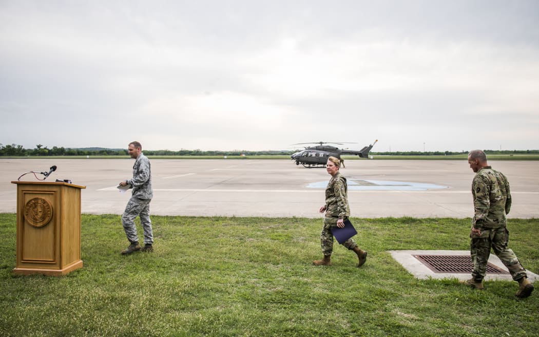 Travis Walters, Brigadier General Tracy Norris, and Col. Ronald Burket take the podium to address members of the media on April 6, 2018 in Austin, Texas.