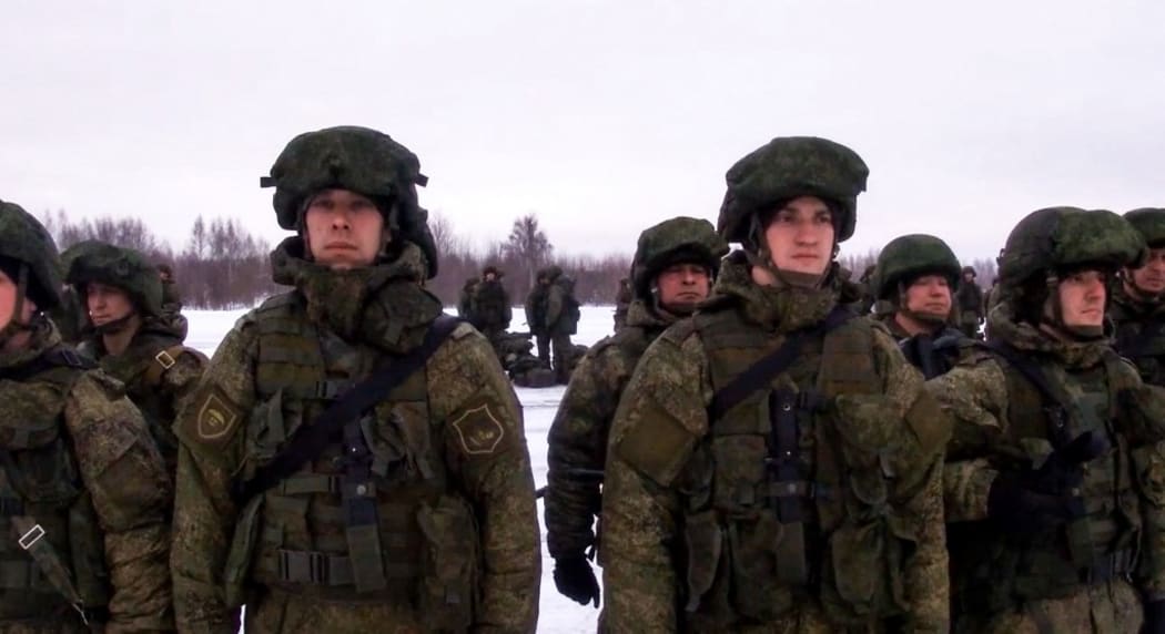 This handout image grab taken on January 6, 2022 and released on January 7, 2022 by the Russian Defence Ministry, shows Russian paratroopers boarding a military cargo plane to depart to Kazakhstan at the airport of Ivanovo.