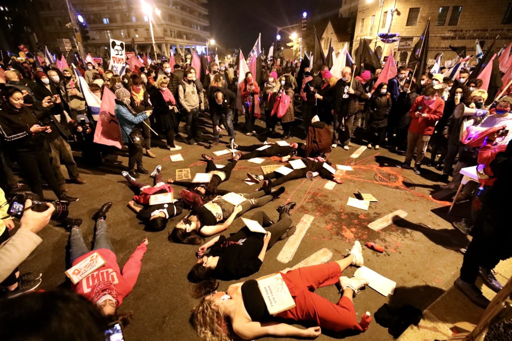 People protest against Israeli Prime Minister Benjamin Netanyahu, demanding his resignation over corruption cases and struggle to combat Covid-19 cases, in West Jerusalem on December 19, 2020.