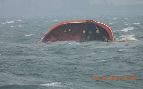 This handout photo taken on July 25, 2024 and received from the Philippine Coast Guard (PCG) shows part of MT Terra Nova oil tanker after it sank off Manila Bay. A Philippine-flagged tanker MT Terra Nova carrying 1.4 million litres of industrial fuel oil capsized and sank off Manila on July 25, authorities said, as they raced against time to contain the spill. (Photo by Handout / Philippine Coast Guard (PCG) / AFP)