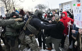 Protestors clash with federal agents outside the Bishop Henry Whipple Federal Building in Saint Paul, Minnesota, on January 8, 2026.