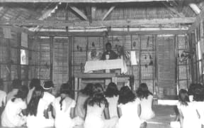 The last church service on Bikini Atoll shortly before the islanders were removed by the U.S. Navy for the start of nuclear weapons testing on the atoll. Photo: US Navy.