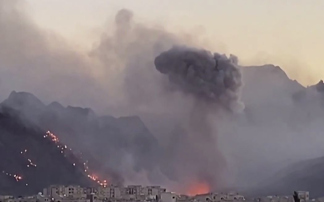 Smoke rising from airstrikes in Baharestan, Iran.