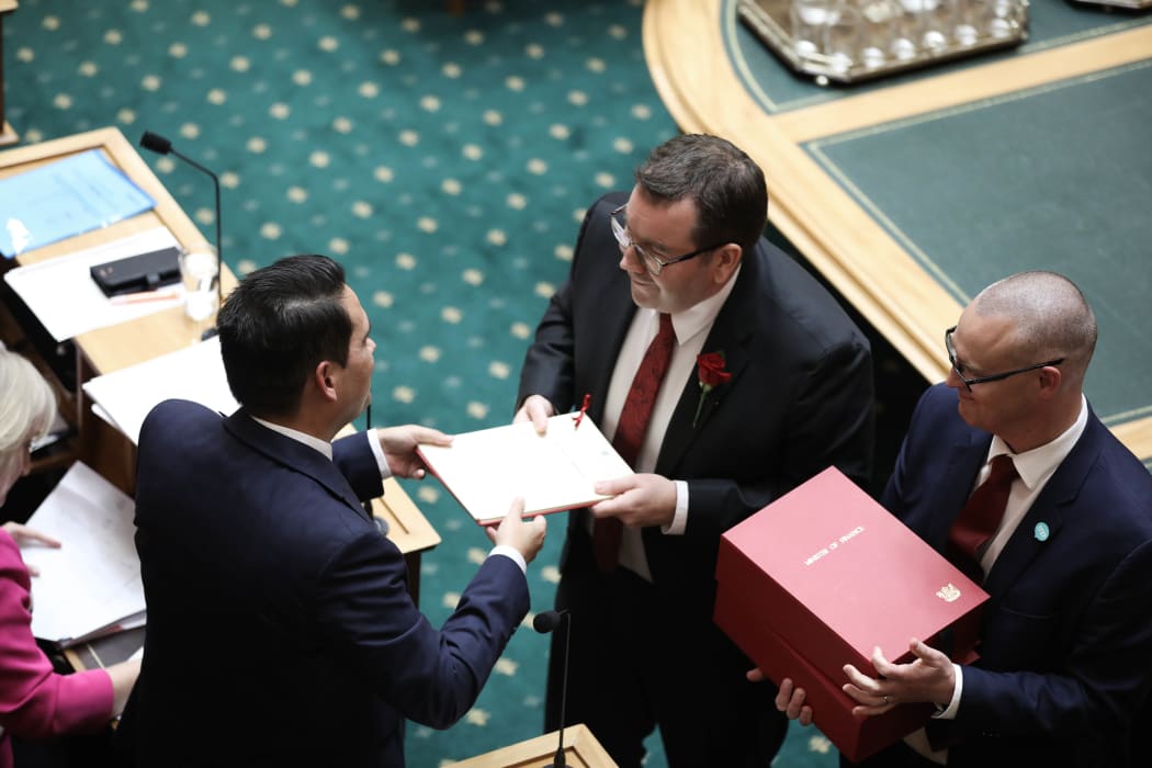 Finance Minister hands his Budget 2018 speech to the National Party leader Simon Bridges.