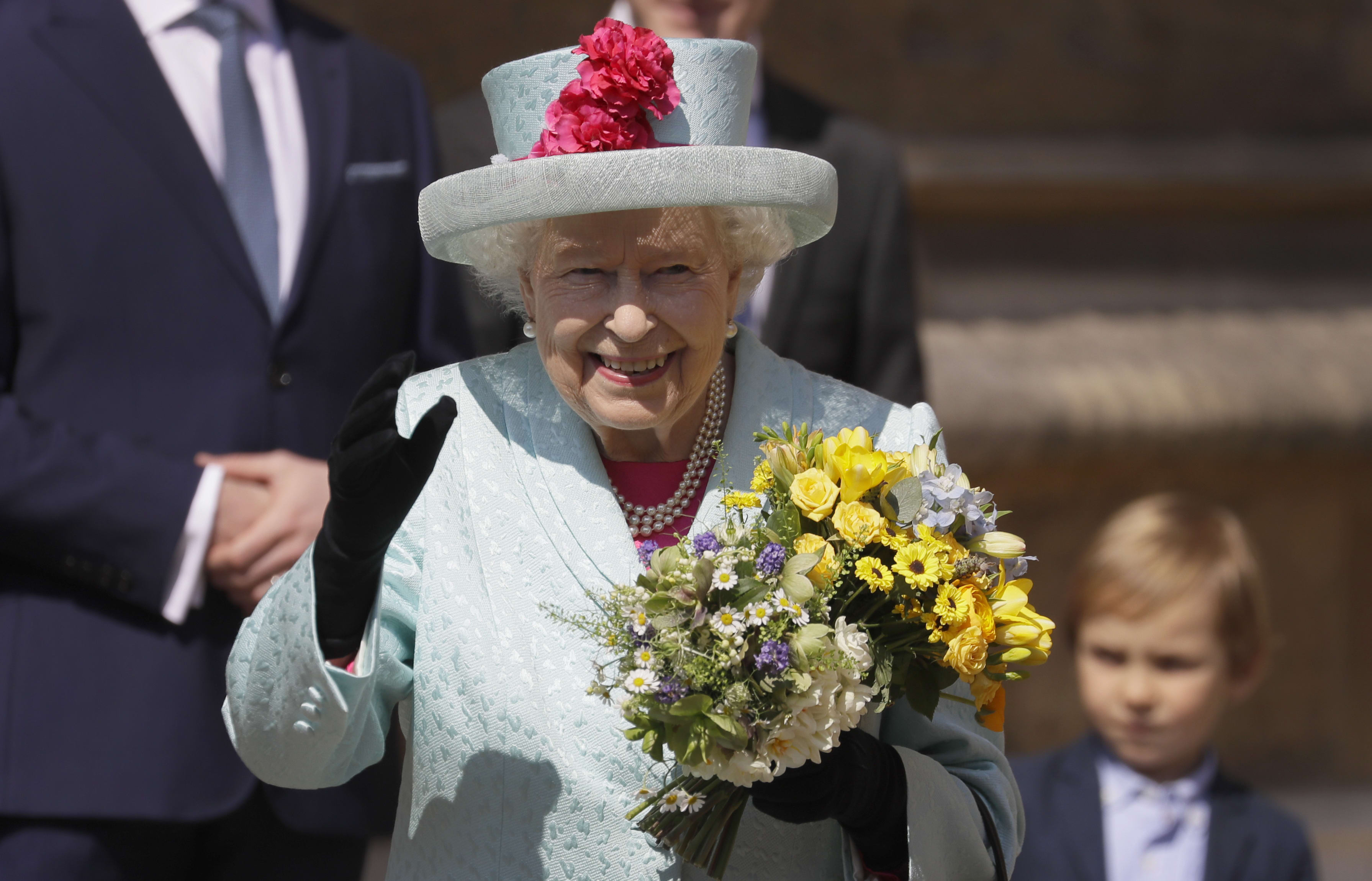 Queen Elizabeth II smiles and waves to members of the public as she leaves after attending the Easter Mattins Service at St. George's Chapel, Windsor Castle on April 21, 2019.