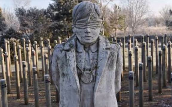 The Shot at Dawn Memorial features a statue of a blind-folded man with his hands tied behind his back waiting to be executed by firing squad.