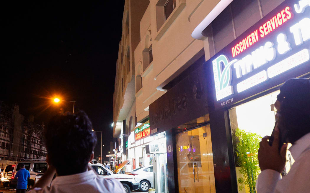 People film projectiles over Doha in Qatar on 23 June, 2025. Qatar on 23 June, 2025 condemned an Iranian attack on the largest US military base in the region, hosted in the Gulf state, calling it a  "flagrant violation" of its sovereignty".