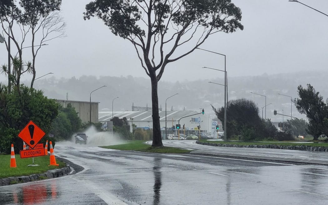 Signs warning of flooding on Portsmouth Drive in Dunedin.