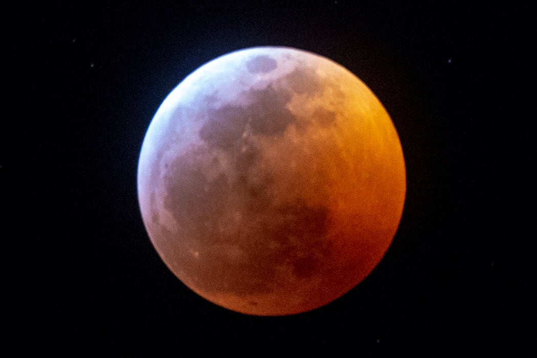 Earth's shadow almost totally obscures the view of the so-called Super Blood Wolf Moon during a total lunar eclipse.
