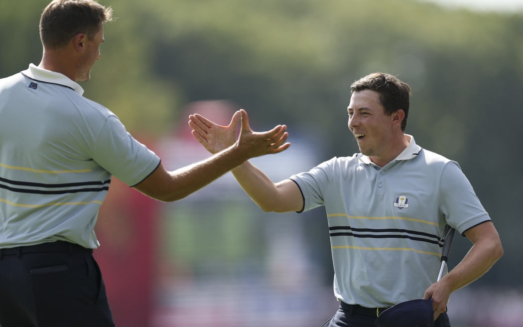 Matt Fitzpatrick and Ludvig Aberg celebrate their Team Europe victory in their foursomes match against Scottie Scheffler and Russell Henley of Team United States at the Ryder Cup on Bethpage Black Course, New York.   27 September, 2025. (Richard Heathcote/Getty Images/AFP)