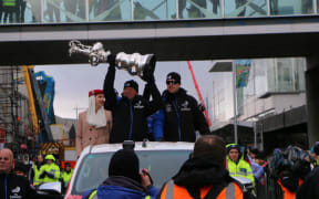 Team New Zealand hold the Auld Mug aloft in the Christchurch parade.