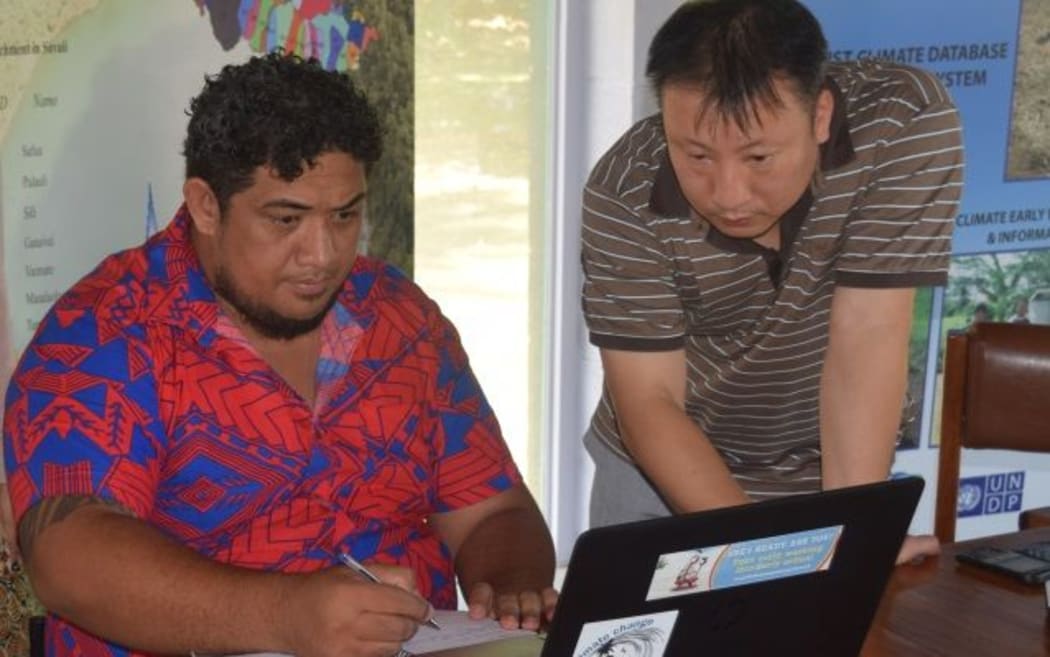 Principal Scientific Officer, Tile Tofaeono running the Climate Prediction software with team from APEC Climate Center.