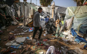 Palestinians are checking the damage at a makeshift camp for displaced people in front of the Al-Aqsa Martyrs Hospital in Deir al-Balah in the central Gaza Strip, after it was hit by an Israeli bombardment on March 31, 2024, amid the ongoing battles between Israel and the Hamas militant group. (Photo by Majdi Fathi/NurPhoto) (Photo by MAJDI FATHI / NurPhoto / NurPhoto via AFP)
