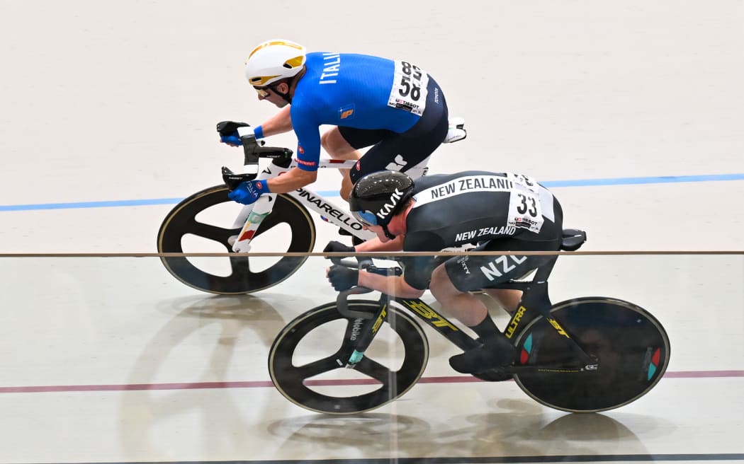 Elia Viviani of Italy (top) and New Zealand's Campbell Stewart contest the men's elimination race at the track cycling world championships.