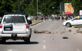 Rocks on the road following the rioting in Honiara.