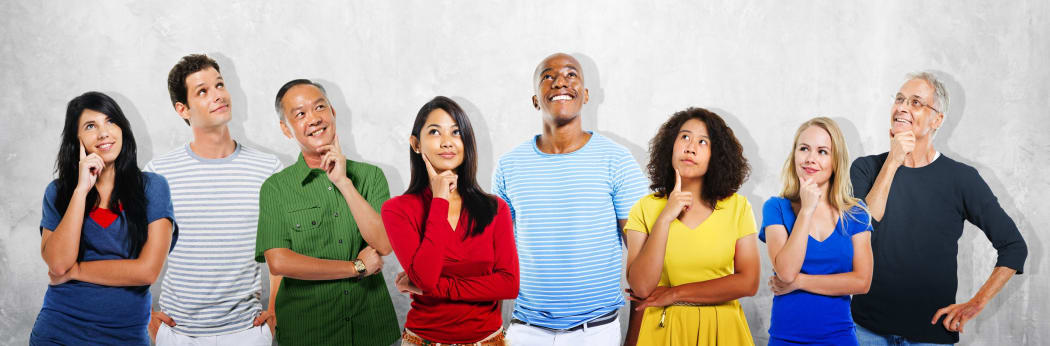 Eight diverse people looking upward with curious expressions