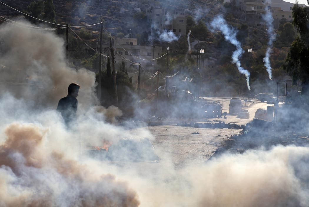 Palestinian demonstrators clash with Israeli soldiers in the West Bank yesterday as violence across the occupied territories simmers.