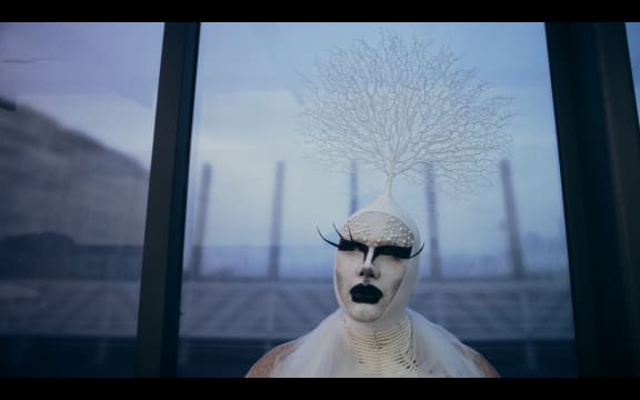 Misty Frequency (They/Them) on Karangahape Road at the bus shelter