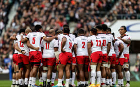 Tonga huddle together during their 69-3 defeat by England at Twickenham.