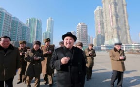 This undated picture released from North Korea's official Korean Central News Agency (KCNA) on 26 January, 2017 shows North Korean leader Kim Jong-Un, centre,  inspecting housing blocks at a construction site at Ryomyong Street in Pyongyang.