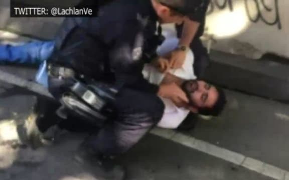Police detain a man after the Flinders Street incident.