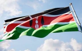 National state flag of Kenya fluttering at sky background.