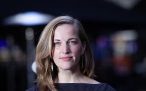 This is a head and shoulders photo of Clare. She is stood on the street, but the background is very soft focus.