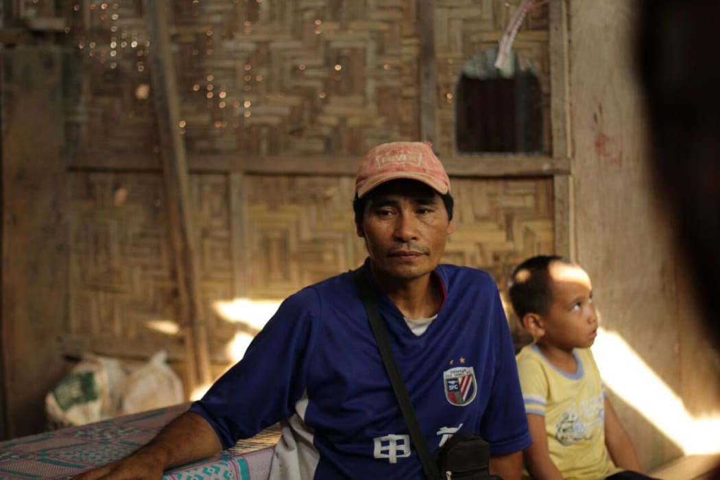 “I think that my children will follow my footsteps”: Vincente Barrios sits in his home with his youngest son.