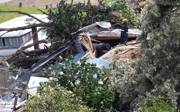 Officials work at the scene of todays landslide at the Beachside Holiday Park in Mt Maunganui.22 January 2026 Photograph by Alan Gibson.