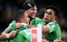 Highlanders' players Aaron Smith, Elliot Dixon and Malakai Fekitoa celebrate.