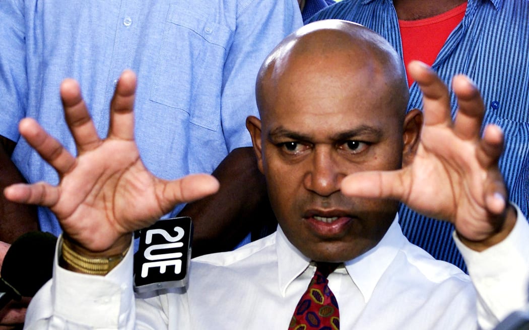 (FILE) Photo dated 28 May 2000 shows coup leader George Speight announcing at Parliament House in Suva that he plans to rule the troubled South Pacific archipelago by decree.  Speight, now in custody on charges of treason, won the seat of Tailevu North for his Conservative Alliance party in the first elections since his gunmen stormed Parliament and overthrew Indo-Fijian prime minister Mahendra Chaudhry's government.  AFP PHOTO/Torsten BLACKWOOD (Photo by TORSTEN BLACKWOOD / AFP FILES / AFP)