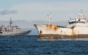 HMNZS Wellington (L) gathering evidence of illegal fishing in Antarctic waters.